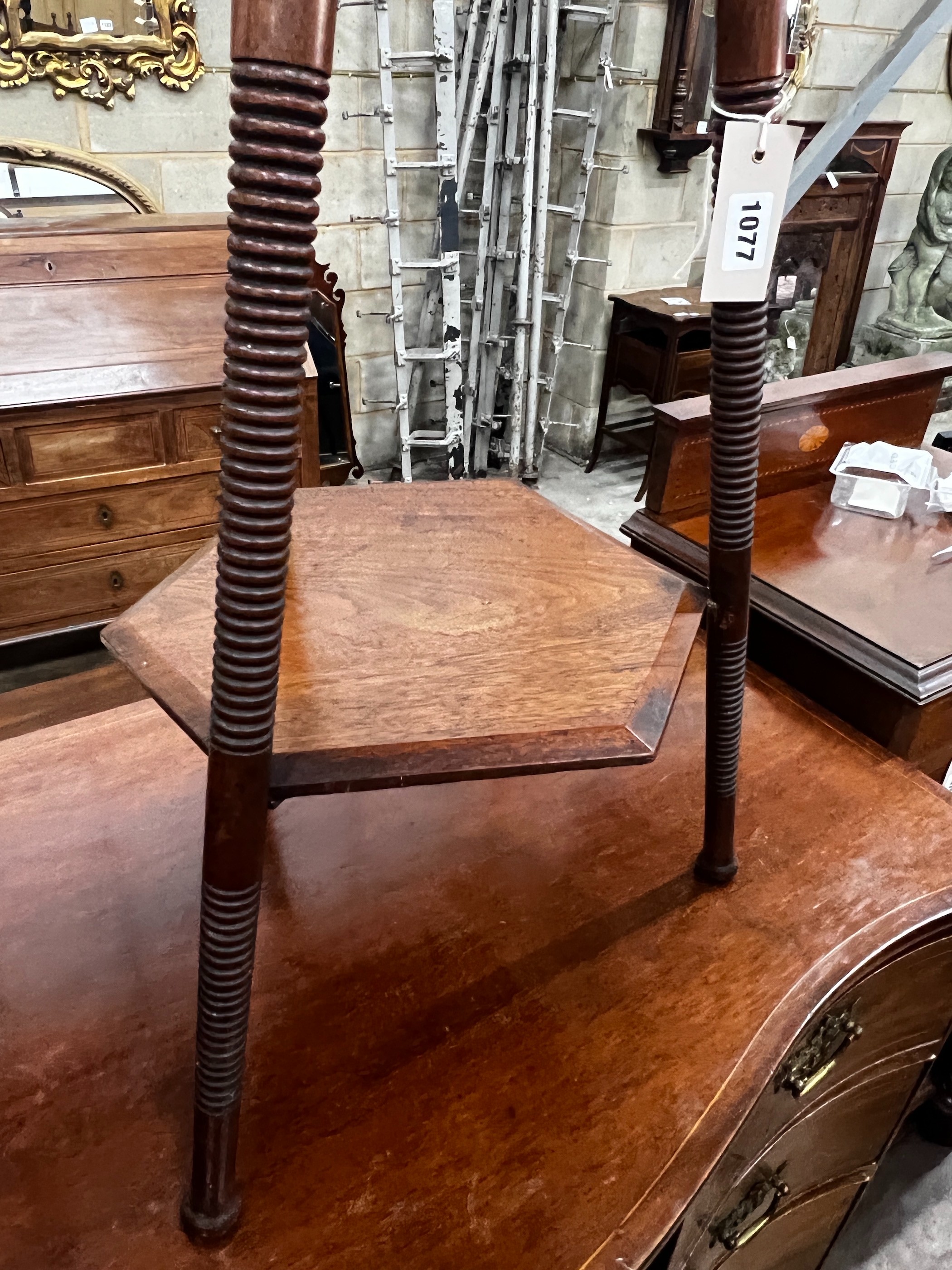 A Liberty & Co. hexagonal oak two tier occasional table, width 38cm, height 66cm